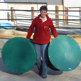 Female carrying an empty Hay Hutch in each hand